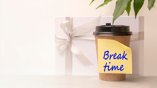 A handwritten note on a disposable coffee cup Break time