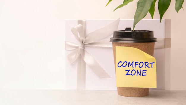 A handwritten note on a disposable coffee cup comfort zone