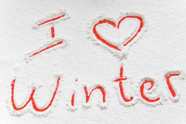 Handwritten text I love winter on the snowy background