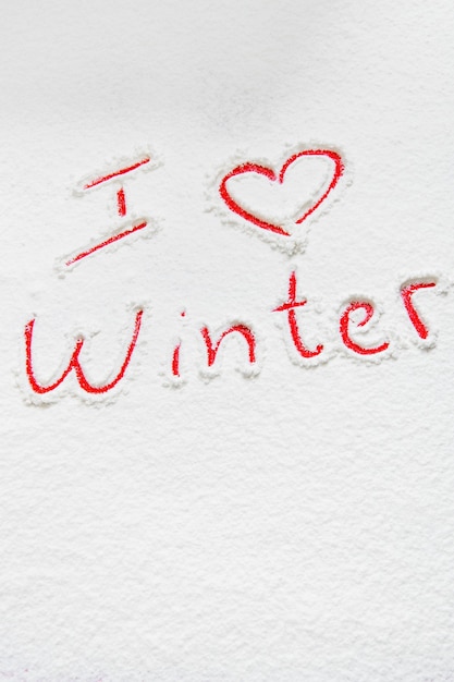 Handwritten text I love winter on the snowy background