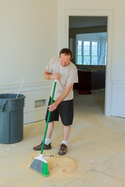 Handyman cleaning the window with squeegees in a new house the worker cleans the new house