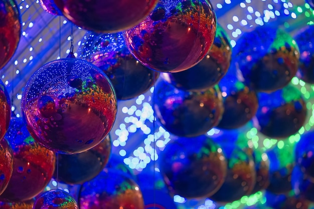 Hanging blue red ornaments ball with colorful blur background in a decorative tunnel