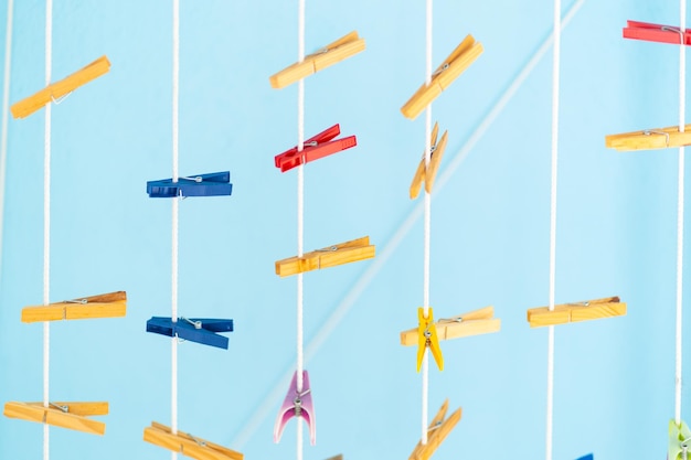 Hanging clothespins with a blue background