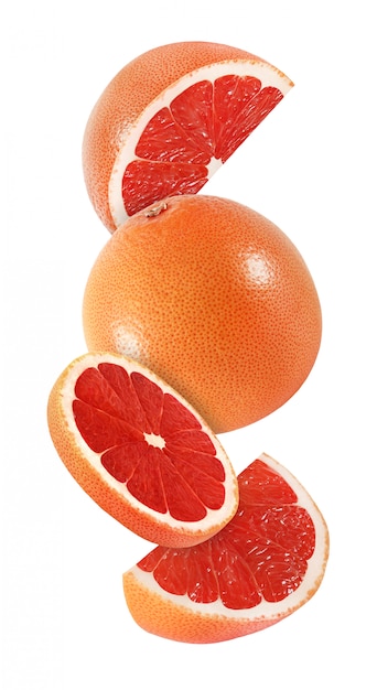 Hanging, falling and flying piece of grapefruit fruits isolated on white background with clipping path