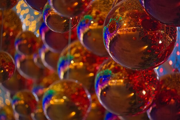 Hanging gold red ornaments ball with colorful blur background in a decorative tunnel