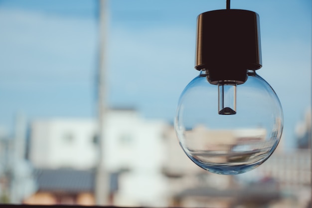 Hanging Light Bulb near glass window