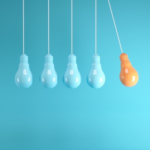 Hanging light bulbs with glowing one different idea on light blue background 