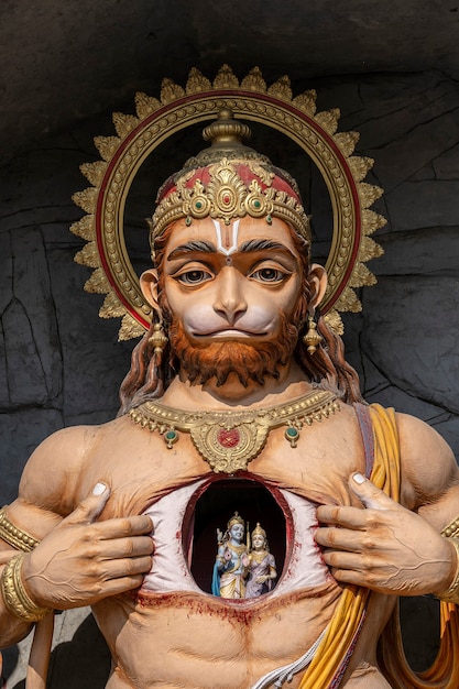 Hanuman statue, Hindu idol near Ganges River, Rishikesh, India. Sacred places for pilgrims. Statue that portray Lord Hanuman tear open his chest and reveal Lord Rama and Sita inside it, in heart