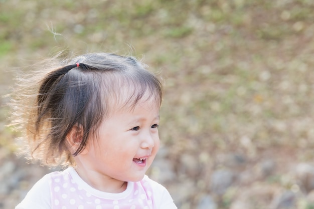 happily smiling girl walks in the park with her family sunset time