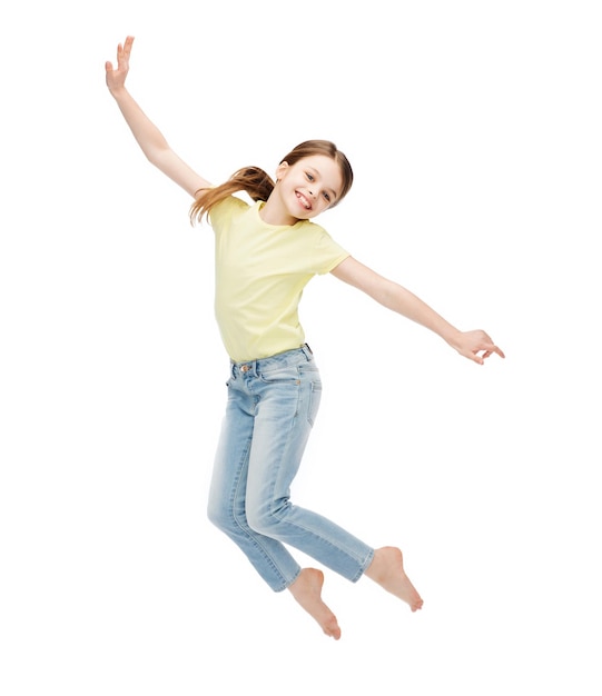 happiness, activity and child concept - smiling little girl jumping