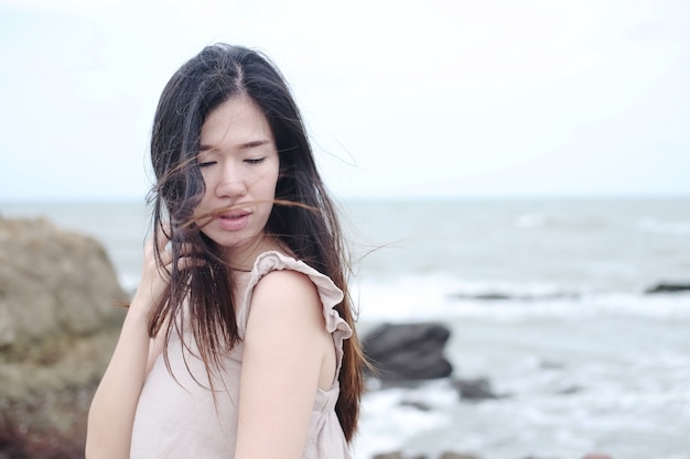 Happiness of asian woman is standing on wooden bridge Extending into the sea on Holiday