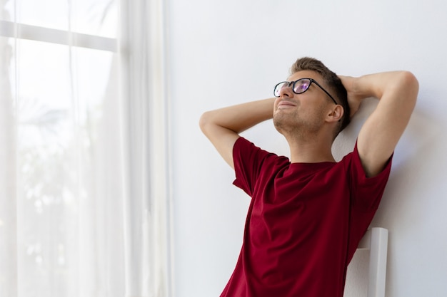 Happiness caucasian man smiling in white room