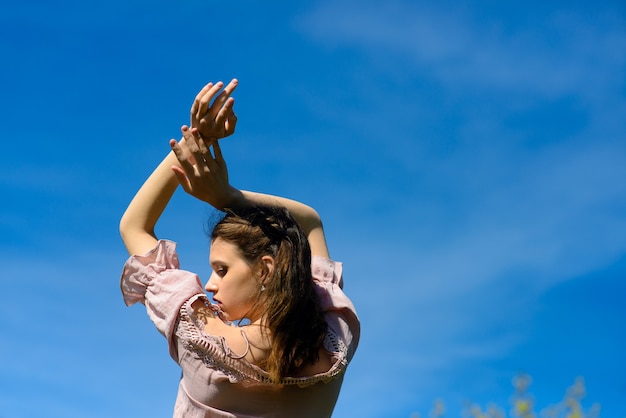 Happiness freedom concept. Woman happy smiling joyful with arms up dancing, summer holidays.