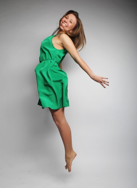 Happiness freedom and people concept smiling young woman jumping in air over white background