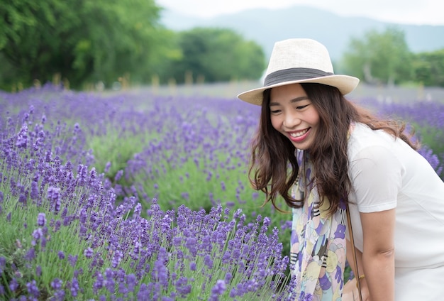 Happiness lady enjoy with lavender garden, selective focus on lady's face