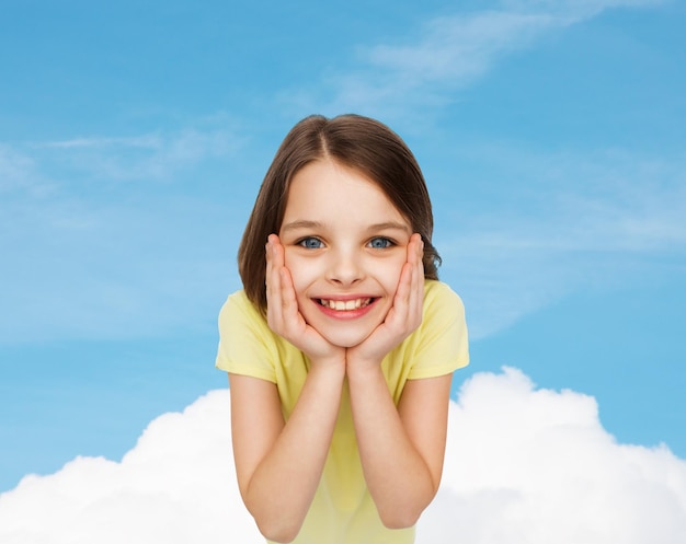 happiness and people concept - smiling little girl holding head over white background