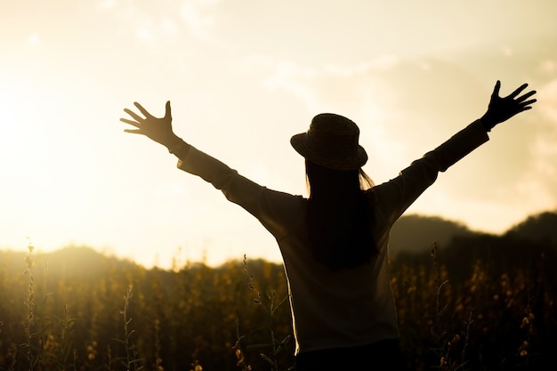 Happiness woman stay outdoor in flower garden under sunlight