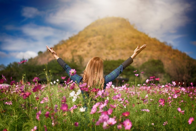 Happiness woman stay outdoor in flower garden under sunlight