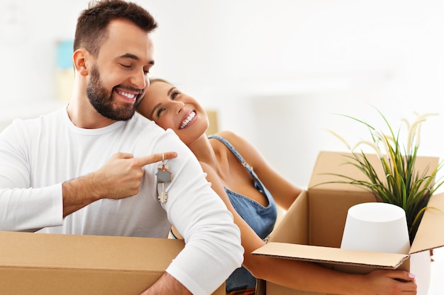 happy adult couple moving out or in to new home