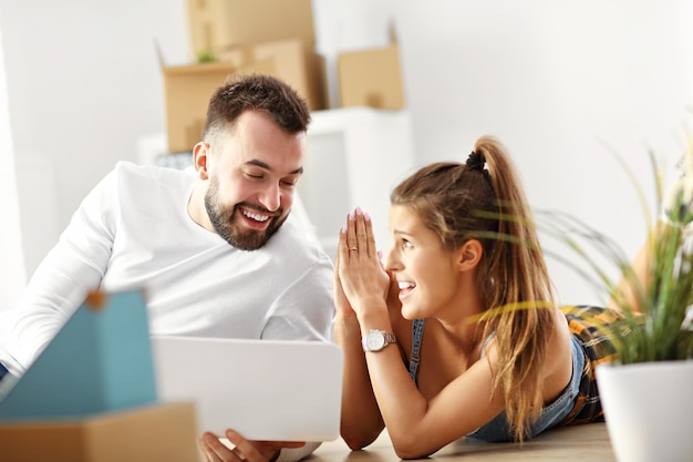 happy adult couple moving out or in to new home