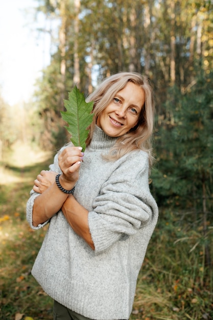 Happy adult woman in autumn forest