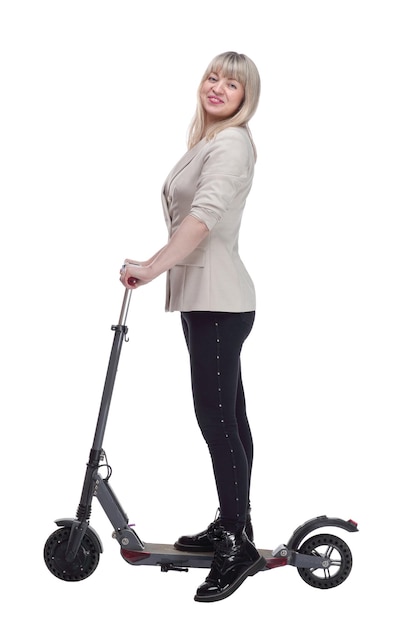 Happy adult woman with electric scooter looking at you 