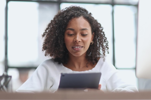 Happy african american businesswoman using digital tablet