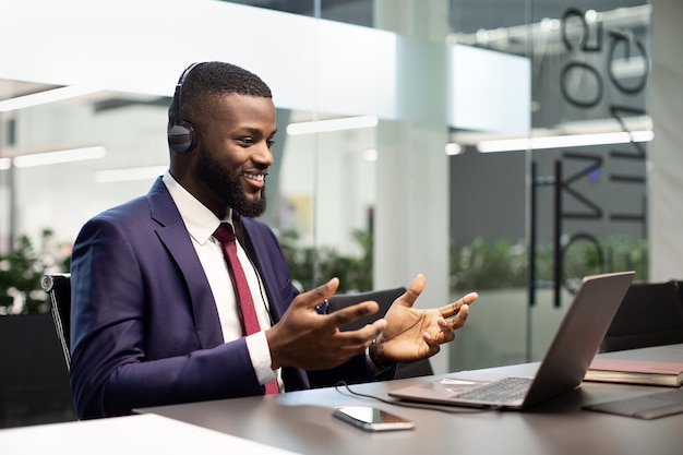 Happy african american ceo having video call at office