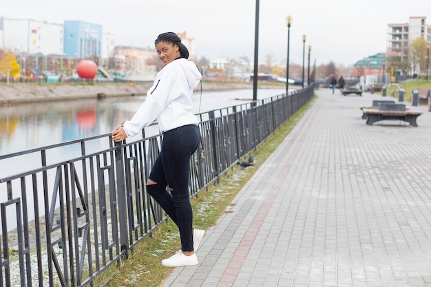 The happy African American woman in a full-length Park