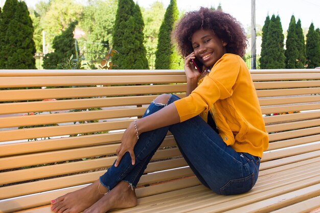 The Happy African American woman on the street talking on the phone