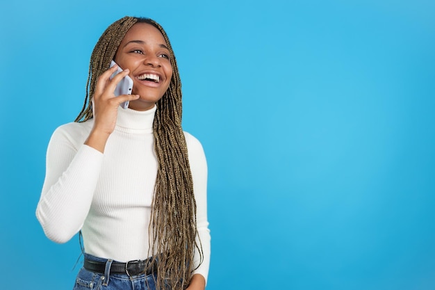 Happy african woman talking on the phone