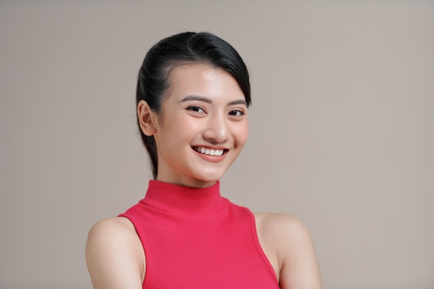 Happy asia girl posing with crossed arms and looking at camera