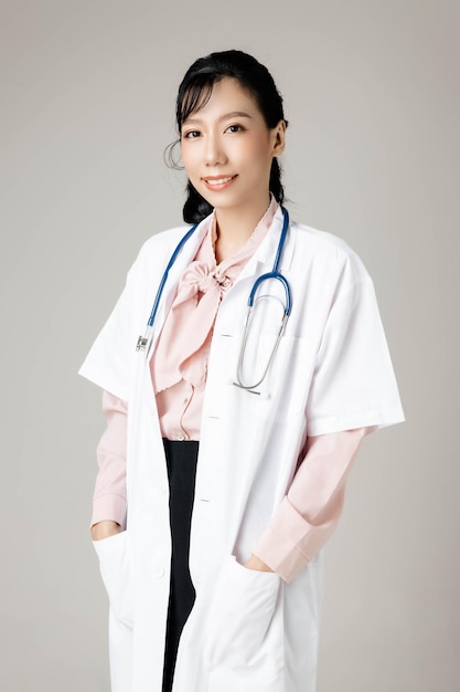 Happy Asian beautiful working woman in office clothing smiling and on gray isolated background