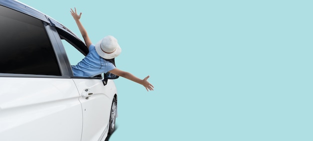 Happy asian child girl in car summer vacation concept isolated on blue background with Clipping paths for design work empty free space