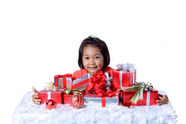 Happy asian child holding Christmas presents. 