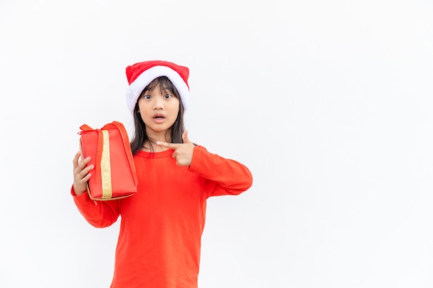 Happy Asian child in Santa red hat holding Christmas presents. Christmas time.on white background.