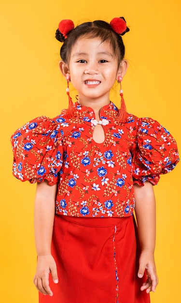 Happy Asian Chinese little girl smile wearing red cheongsam