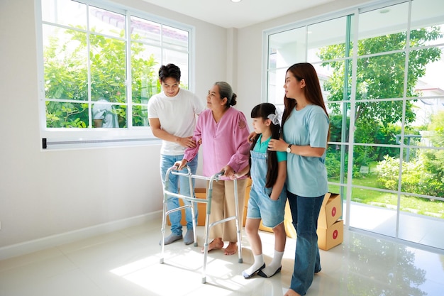 Happy asian family feel excitement moving to new house Grandmother using walker father