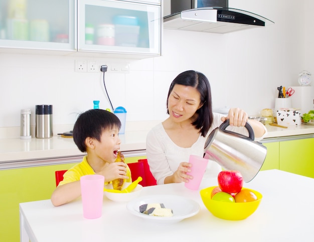 Happy asian family having breakfast in the kitchen