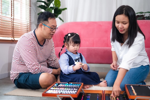 Happy Asian family smiling together at home