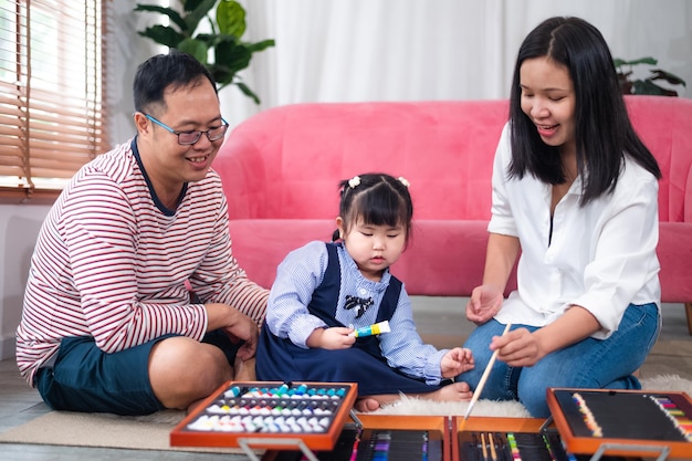 Happy Asian family smiling together at home