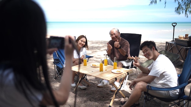 Happy Asian family with kids travel and relaxing on tropical beach during summer holiday. Togetherness and outdoor activity lifestyle.