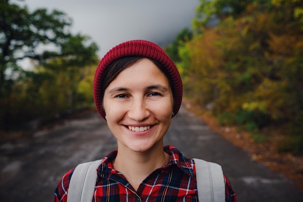 Happy Asian girl backpack in road and forest background