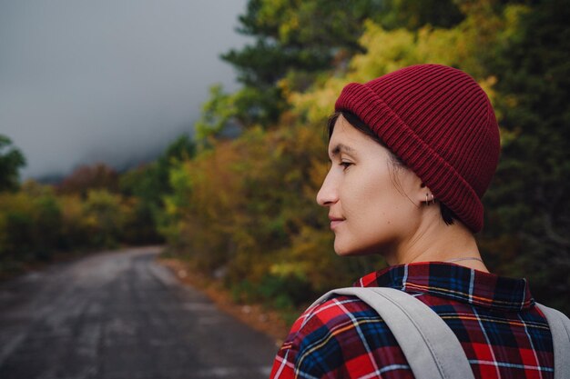 Happy Asian girl backpack in road and forest background