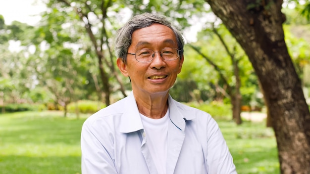 Happy asian man standing at the park.