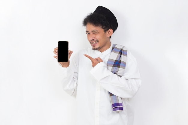 happy asian muslim man portrait showing and demonstrating mobile phone screen isolated on white