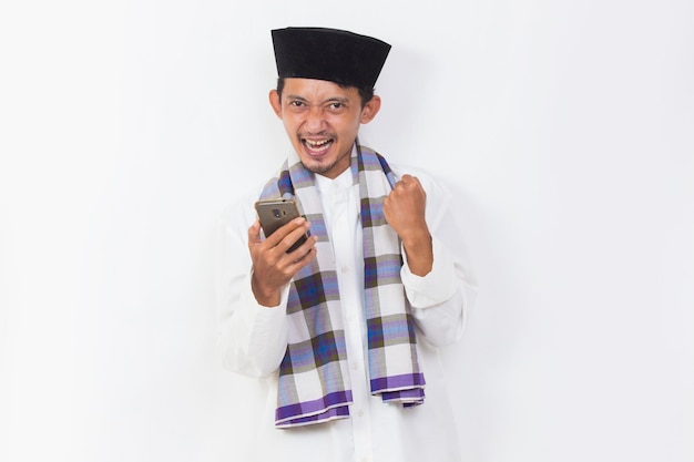 happy asian muslim man portrait using mobile phone isolated on white background