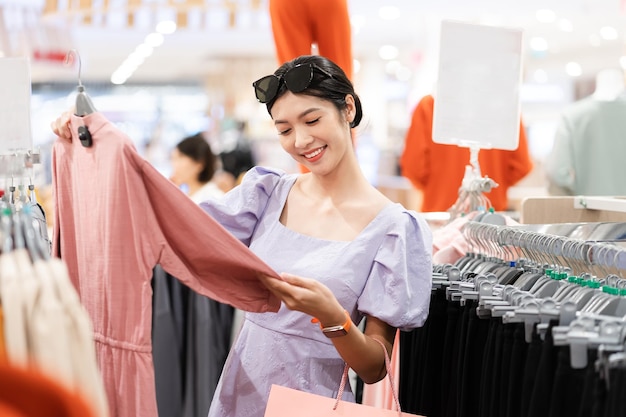 Happy Asian woman shopping at mall