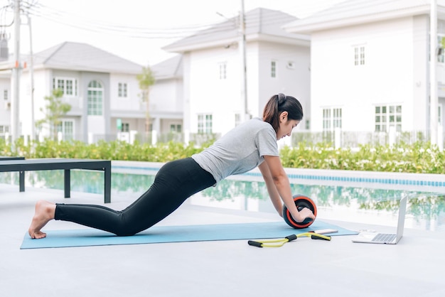 Happy asian woman stretching exercise and yoga workout in the morning at home