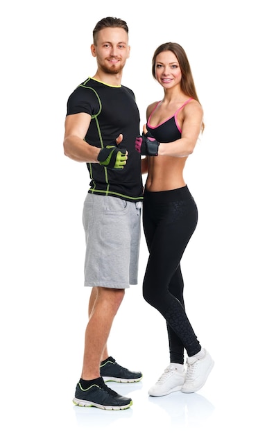 Happy athletic man and woman after fitness exercise with a thumb up on the white background